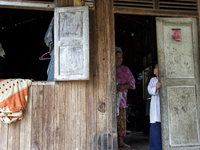 Female worker and her daughter are looking and smiling each other at their house / Kampung Keluat, Kelantan / Malaysia. *360 hours of waitin...