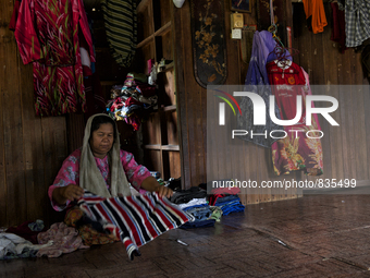 Female worker is fold up the laundries / Kampung Keluat, Kelantan / © Chris Jung
 (