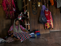 Female worker is fold up the laundries / Kampung Keluat, Kelantan / © Chris Jung
 (