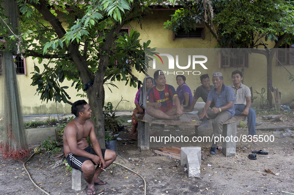 Charcoal workers are resting at their house. When they are not working they use to spend their time at the house / Kampung Keluat, Kelantan...