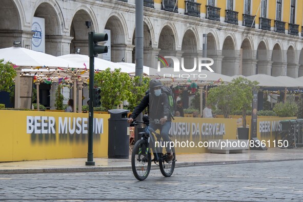 A delivery man wearing a protective mask is seen riding his bicycle on a street in Baixa district. Lisbon, June 03, 2022. According to data...