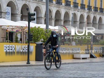 A delivery man wearing a protective mask is seen riding his bicycle on a street in Baixa district. Lisbon, June 03, 2022. According to data...