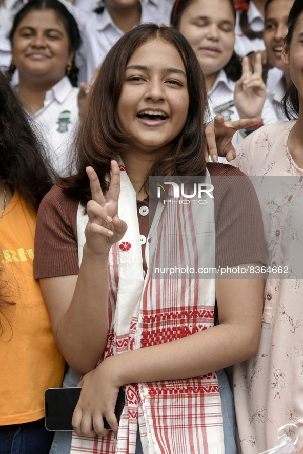 Student of St. Mary's English High School Ashlesha Sarma showing V sign after stood 7th rank in the HSLC class 10 examination, in Guwahati,...