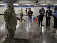 José Miguel Moctezuma, characterised as Don Ferro Ferrocarrilero, during a performance as a living statue inside the Zócalo metro station in...