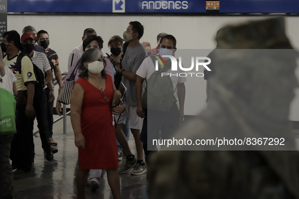 A group of people watch José Miguel Moctezuma, characterised as Don Ferro Ferrocarrilero, during a performance as a living statue inside the...