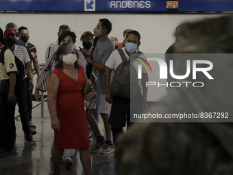 A group of people watch José Miguel Moctezuma, characterised as Don Ferro Ferrocarrilero, during a performance as a living statue inside the...