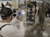 A person portrays José Miguel Moctezuma, characterised as Don Ferro Ferrocarrilero, during a performance as a living statue inside the Zócal...