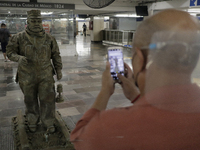 A person portrays José Miguel Moctezuma, characterised as Don Ferro Ferrocarrilero, during a performance as a living statue inside the Zócal...