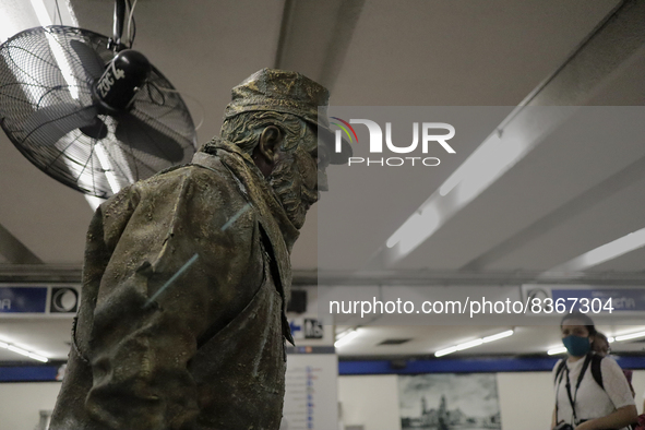 José Miguel Moctezuma, characterised as Don Ferro Ferrocarrilero, during a performance as a living statue inside the Zócalo metro station in...