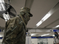 José Miguel Moctezuma, characterised as Don Ferro Ferrocarrilero, during a performance as a living statue inside the Zócalo metro station in...