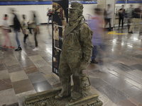 José Miguel Moctezuma, characterised as Don Ferro Ferrocarrilero, during a performance as a living statue inside the Zócalo metro station in...