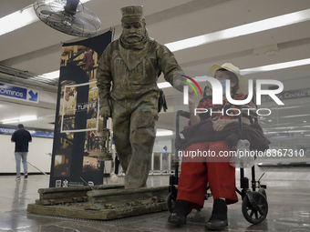 José Miguel Moctezuma, characterised as Don Ferro Ferrocarrilero, lives with an elderly woman during a performance as a living statue inside...