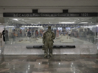 José Miguel Moctezuma, characterised as Don Ferro Ferrocarrilero, during a performance as a living statue inside the Zócalo metro station in...