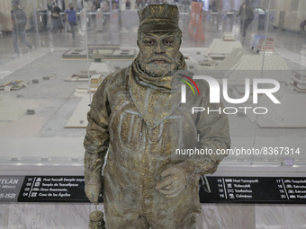 José Miguel Moctezuma, characterised as Don Ferro Ferrocarrilero, during a performance as a living statue inside the Zócalo metro station in...