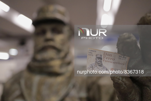 José Miguel Moctezuma, characterised as Don Ferro Ferrocarrilero, holds a ticket with his image during a performance as a living statue insi...