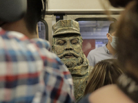 José Miguel Moctezuma, characterised as Don Ferro Ferrocarrilero, during a performance as a living statue inside a carriage in the Zócalo me...