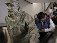 José Miguel Moctezuma, characterised as Don Ferro Ferrocarrilero, during a performance as a living statue on the escalators inside the Bella...