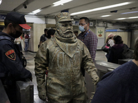 José Miguel Moctezuma, characterised as Don Ferro Ferrocarrilero, during a performance as a living statue inside the Bellas Artes metro stat...