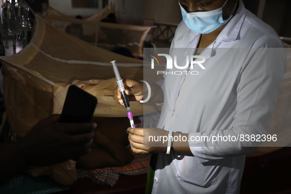 A medical worker collects sample blood of a dengue patient in a special ward of Mugda general hospital in Dhaka, Bangladesh on June 11, 2022...