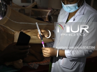 A medical worker collects sample blood of a dengue patient in a special ward of Mugda general hospital in Dhaka, Bangladesh on June 11, 2022...