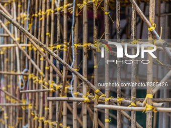 Hong Kong, China, 11 Jun 2022, Bamboo scaffoldings are held together with yellow plastic binders. (