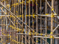 Hong Kong, China, 11 Jun 2022, Bamboo scaffoldings are held together with yellow plastic binders. (