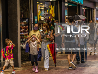 Hong Kong, China, 11 Jun 2022, A family wearing face masks walks on Sai Yeung Choi South Street in Mongkok. (