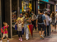 Hong Kong, China, 11 Jun 2022, A family wearing face masks walks on Sai Yeung Choi South Street in Mongkok. (