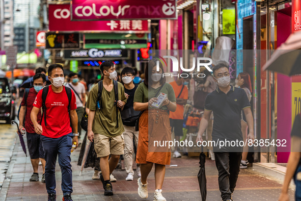 Hong Kong, China, 11 Jun 2022, Masked people walk on Sai Yeung Choi South Street in Mongkok. 