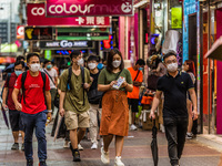 Hong Kong, China, 11 Jun 2022, Masked people walk on Sai Yeung Choi South Street in Mongkok. (