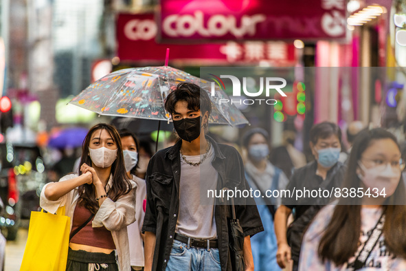 Hong Kong, China, 11 Jun 2022, Masked young people walk on Sai Yeung Choi South Street in Mongkok. 