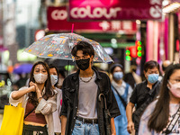 Hong Kong, China, 11 Jun 2022, Masked young people walk on Sai Yeung Choi South Street in Mongkok. (