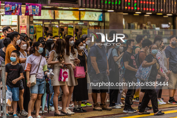 Hong Kong, China, 11 Jun 2022, People stack up at a street crossing in Mongkok. 