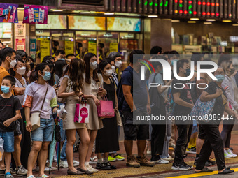 Hong Kong, China, 11 Jun 2022, People stack up at a street crossing in Mongkok. (