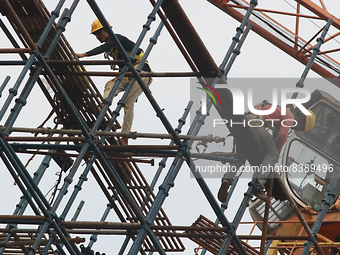  Labourers work at a construction site of a metro rail station in Kolkata, India, June 12,2022. (