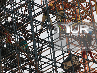  Labourers work at a construction site of a metro rail station in Kolkata, India, June 12,2022. (