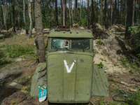 Remains of a russian truck cabin with the V symbol in the forests around Kyiv. Russian troops occupied large extensions of the forests aroun...