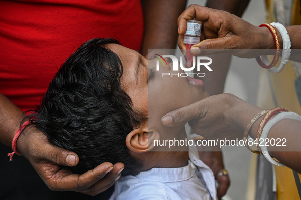 A boy receives polio drops during a pulse polio immunisation programme in Kolkata on June 19 2022. The immunisation programme started in a t...