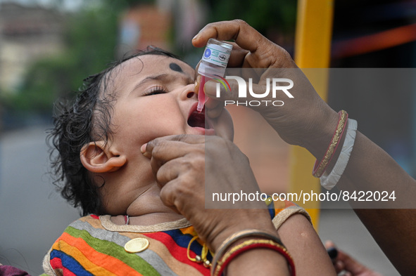 A child receives polio drops during a pulse polio immunisation programme in Kolkata on June 19 2022. The immunisation programme started in a...