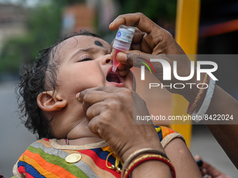 A child receives polio drops during a pulse polio immunisation programme in Kolkata on June 19 2022. The immunisation programme started in a...