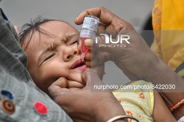 A child receives polio drops during a pulse polio immunisation programme in Kolkata on June 19 2022. The immunisation programme started in a...