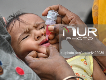 A child receives polio drops during a pulse polio immunisation programme in Kolkata on June 19 2022. The immunisation programme started in a...