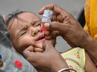 A child receives polio drops during a pulse polio immunisation programme in Kolkata on June 19 2022. The immunisation programme started in a...