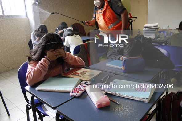 Civil Protection workers spread disinfectant inside class rooms of a primary school  to avoid new Covid-19 infections after an increase of C...