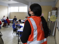 Civil Protection workers spread disinfectant inside class rooms of a primary school  to avoid new Covid-19 infections after an increase of C...