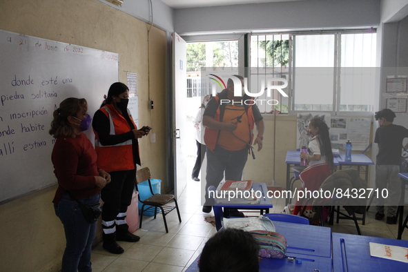 Civil Protection workers spread disinfectant inside class rooms of a primary school  to avoid new Covid-19 infections after an increase of C...