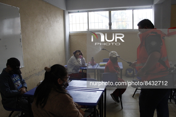 Civil Protection workers spread disinfectant inside class rooms of a primary school  to avoid new Covid-19 infections after an increase of C...