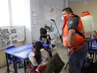 Civil Protection workers spread disinfectant inside class rooms of a primary school  to avoid new Covid-19 infections after an increase of C...