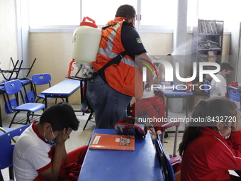 Civil Protection workers spread disinfectant inside class rooms of a primary school  to avoid new Covid-19 infections after an increase of C...