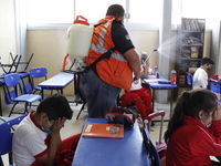 Civil Protection workers spread disinfectant inside class rooms of a primary school  to avoid new Covid-19 infections after an increase of C...